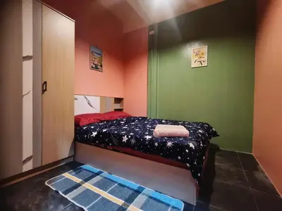 a small bedroom with green and red walls and a bed at Bonanza Patong Beach2 for 2 BR 100m to Beach Grace Room in Patong Beach