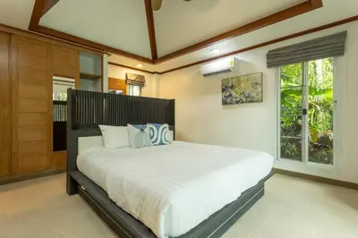 a bedroom with a large bed in a room at 15 Minuets Walk 2 BangTao Beach Fully Loaded v134 in Bang Tao Beach
