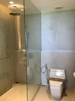 a bathroom with a toilet and a glass shower at Sea View 3BR Duplex in The Sapphire Bay 88 Residence near Patong and Paradise Beach in Patong Beach