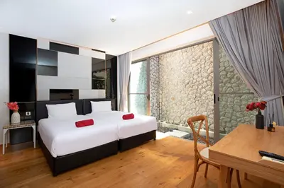 a bedroom with a bed and a table and a desk at Sea View 3BR Duplex in The Sapphire Bay 88 Residence near Patong and Paradise Beach in Patong Beach
