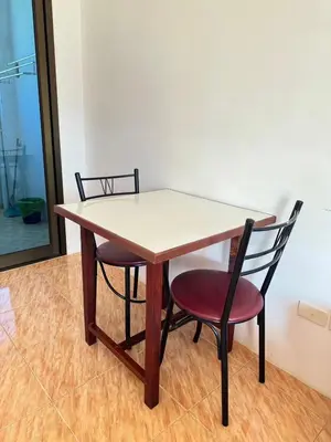 a table and two chairs sitting next to a table at Mood Resotel Kamala in Kamala Beach