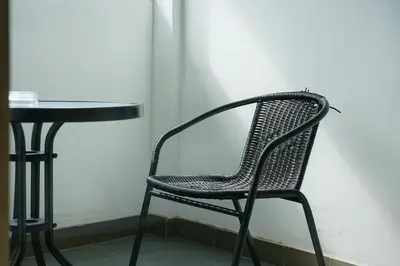 a black chair sitting next to a table at Burning Flame Patong in Patong Beach