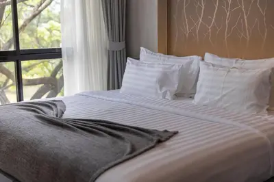 a bed with white sheets and pillows and a window at Fully Loaded Resort everything You Need #C142 in Kamala Beach