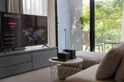 a living room with a flat screen tv on a dresser at Fully Loaded Resort everything You Need #C142 in Kamala Beach