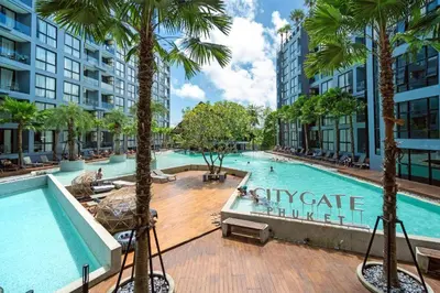a large swimming pool with palm trees in a building at Fully Loaded Resort everything You Need #C142 in Kamala Beach