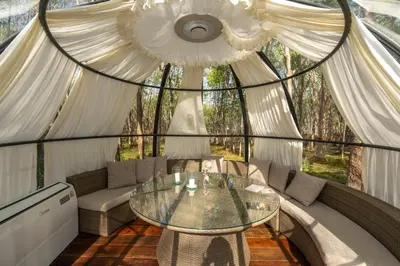 a room with a glass table in a tent at Timber Society Boutique Hideaway in Phuket Town