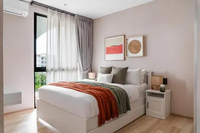 a bedroom with a large bed and a window at Title Halo Orange Sunset 46m2 Naiyang Pool&Gym in Nai Yang Beach