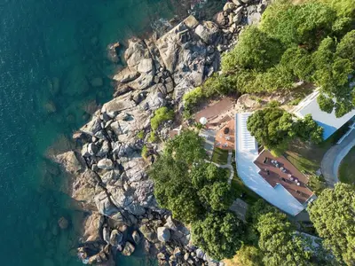 an aerial view of a rocky shore with the ocean at Anona Sunset Boutique in Karon Beach