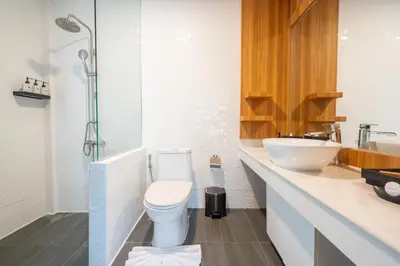a bathroom with a toilet and a sink at Anona Sunset Boutique in Karon Beach