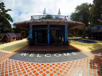 a welcome sign in front of a building at Phi Phi Long Beach Resort & Villa in Phi Phi Don