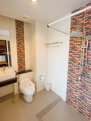 a bathroom with a toilet and a sink and a shower at Melissa Kata Beach Resort in Kata Beach