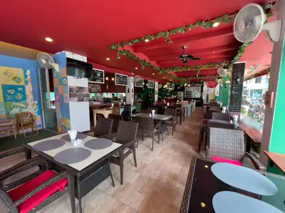 a dining area with tables and chairs in a restaurant at Melissa Kata Beach Resort in Kata Beach