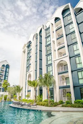 a large building with a pool in front of it at Title Halo Modern Line Pool View Gym Sauna in Nai Yang Beach