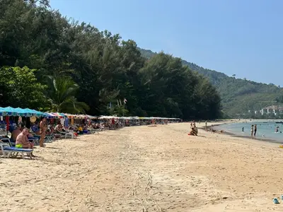 a beach with a bunch of people on it at Title Halo I Sea You Naiyang Pool Gym Sauna in Nai Yang Beach