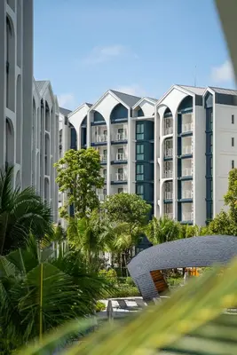 a view of a large apartment building with trees at Title Halo I Sea You Naiyang Pool Gym Sauna in Nai Yang Beach