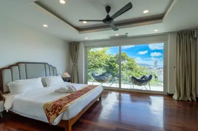 a bedroom with a bed and a large window at Patong 180-degree stunning sea view modern 4-bedroom villa sleeps 10 private pool stunning sunset BBQ in Patong Beach