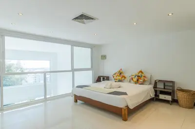 a bedroom with a bed and a large window at Patong 180-degree stunning sea view modern 4-bedroom villa sleeps 10 private pool stunning sunset BBQ in Patong Beach