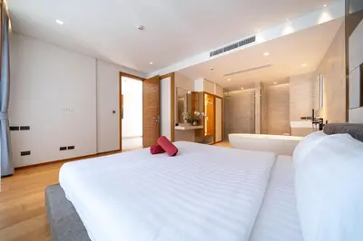 a bedroom with a large white bed and a bath tub at Ocean Bliss - Sapphire Bay 3BR Apartment 812 with Terrace and Awe-Inspiring Views of Patong Bay in Patong Beach