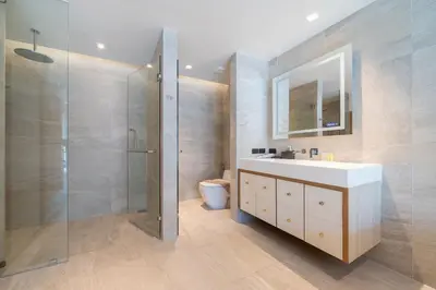 a bathroom with a white sink and a shower at Ocean Bliss - Sapphire Bay 3BR Apartment 812 with Terrace and Awe-Inspiring Views of Patong Bay in Patong Beach