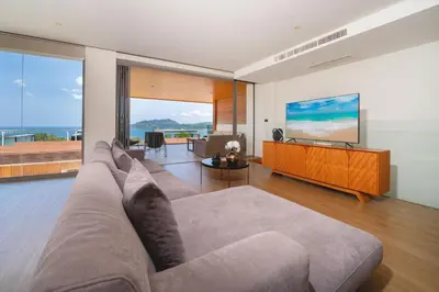 a living room with a large couch and a television at Luxury Ocean View 2BR Apartment 82 in Sapphire Bay Residence, near Patong and Paradise Beach in Patong Beach