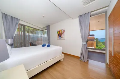 a bedroom with a white bed and a large window at Luxury Ocean View 2BR Apartment 82 in Sapphire Bay Residence, near Patong and Paradise Beach in Patong Beach
