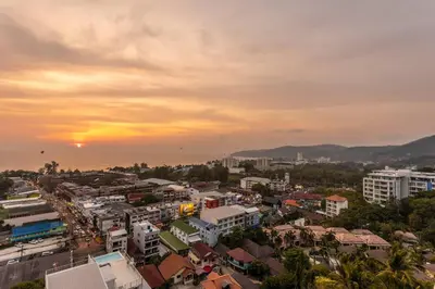 a cityscape of a city with the sunset in the background at Best View In Phuket! 2 Living Rooms 4 BR #C80 in Karon Beach