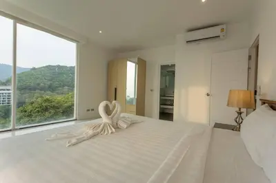 a bedroom with two swans sitting on a bed at Best View In Phuket! 2 Living Rooms 4 BR #C80 in Karon Beach