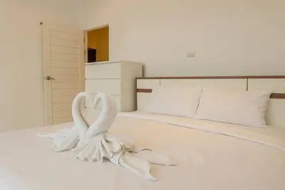 a white bed with two swans forming a heart at Best View In Phuket! 2 Living Rooms 4 BR #C80 in Karon Beach