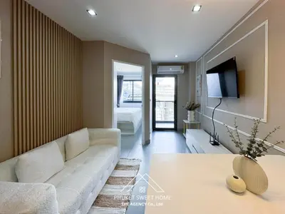 a living room with a white couch and a tv at Tower condo Rawai Phuket 305 in Ban Klang