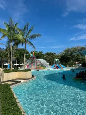 a pool with a water park with people in it at La Vita Stylish apartment in 5 star hotel in Rawai Beach