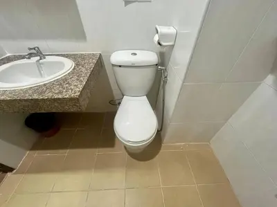 a bathroom with a white toilet and a sink at \u30a2\u30de\u30c6\u30e9\u30b9\u30d1\u30c8\u30f37 in Patong Beach