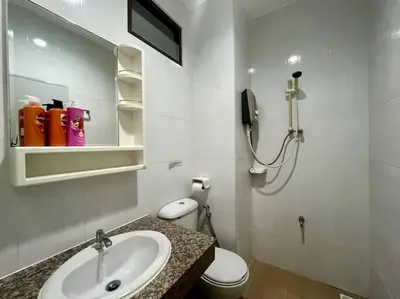 a bathroom with a sink and a toilet and a phone at \u30a2\u30de\u30c6\u30e9\u30b9\u30d1\u30c8\u30f37 in Patong Beach