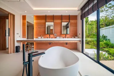 a bath tub in a bathroom with a large window at Banyan Tree Grand Residences by Banyan Living in Phuket Town
