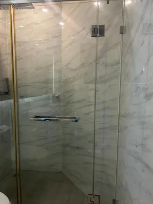 a shower with a glass door in a bathroom at Oceana Kamala Stunning corner Suite Sea View in Kamala Beach