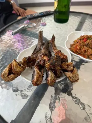 a plate of meat on a table with a bowl of food at \u30d1\u30c8\u30f3\u30eb\u30fc\u30e07 in Patong Beach