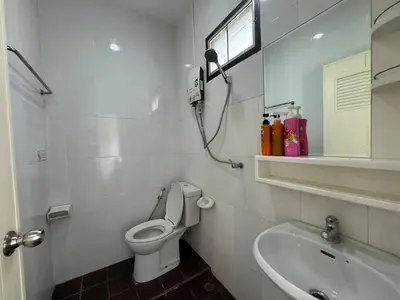 a white bathroom with a toilet and a sink at \u30d1\u30c8\u30f3\u30eb\u30fc\u30e01 in Patong Beach