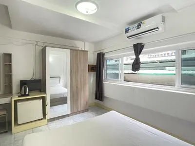 a bedroom with a bed and a window at Nice to CU Guest house in Patong Beach