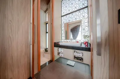 a bathroom with a sink and a mirror at Villa Noon in Patong Beach