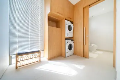 a laundry room with a washing machine and a washer and dryer at Sofia Villa Phuket in Phuket Town