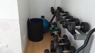 a bunch of dumbbells hanging on a wall at VILLA AP Grand Residence in Kamala Beach
