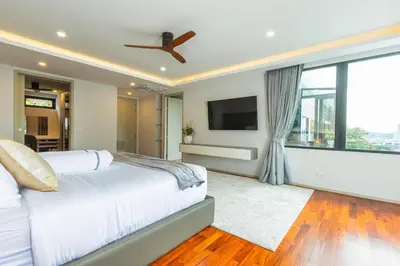 a bedroom with a bed and a flat screen tv at 