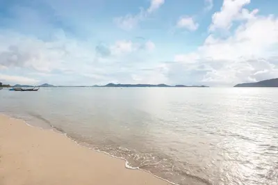 a view of the beach with a boat in the water at Serenity Rawai by Destada in Rawai Beach