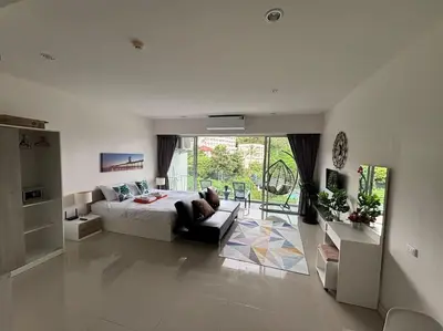 a large white bedroom with a bed and a couch at Chic Condominium Karon B307 in Karon Beach