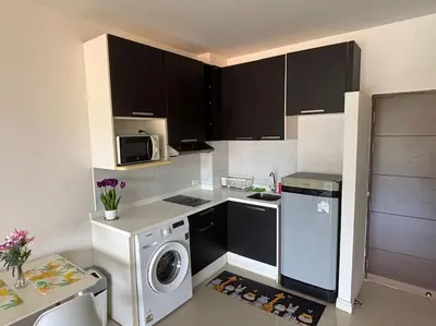 a kitchen with a washing machine and a microwave at Chic Condominium Karon B307 in Karon Beach