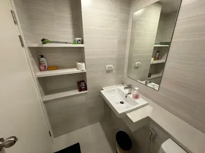 a white bathroom with a sink and a mirror at Phyll Phuket - Luxury Resort-Style Comfort in Ban Rangeng