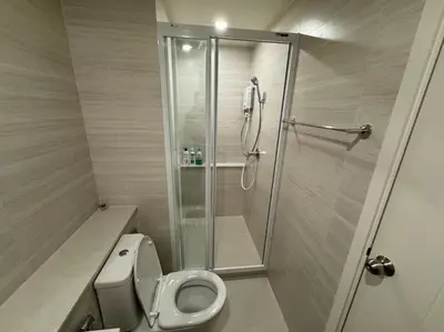 a bathroom with a shower and a toilet at Phyll Phuket - Luxury Resort-Style Comfort in Ban Rangeng