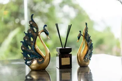 two sculptures of birds are sitting on a table at patong hill villa 3 in Patong Beach