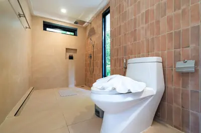 a bathroom with a white toilet in a room at patong hill villa 3 in Patong Beach