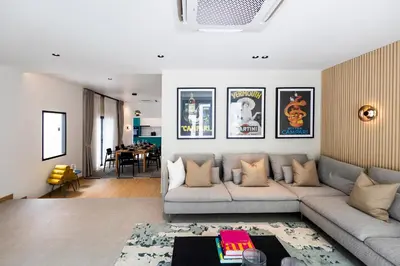 a living room with a couch and a table at 5BR Modern Luxury Pool Villa Patong TPSV140 in Patong Beach