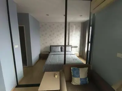 a small bedroom with a bed and a mirror at Zcape Condotel Bangtao Beach in Bang Tao Beach